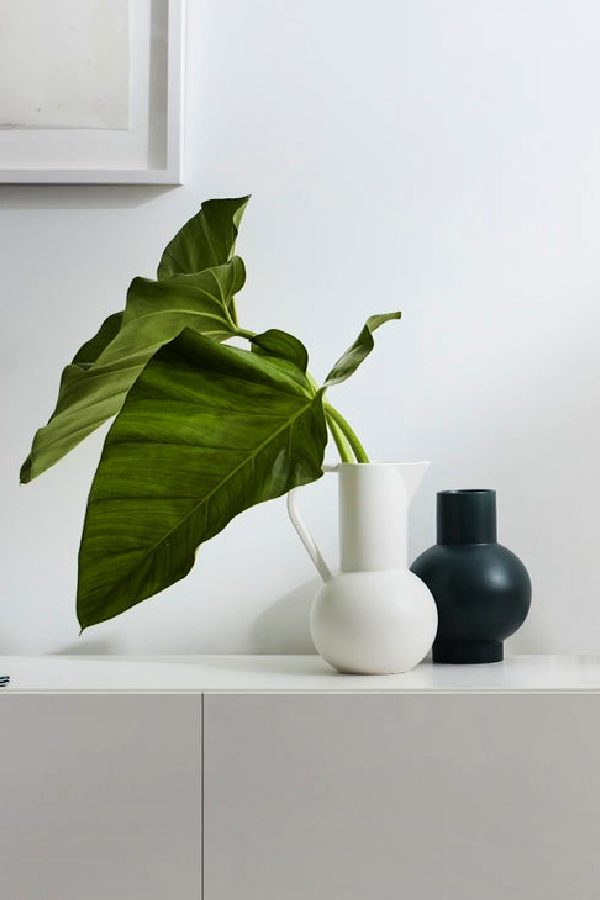 Easy ways to freshen up your family room: Get rid of piles of junk and replace with objects you like looking at. Like this Raawii Strom vase