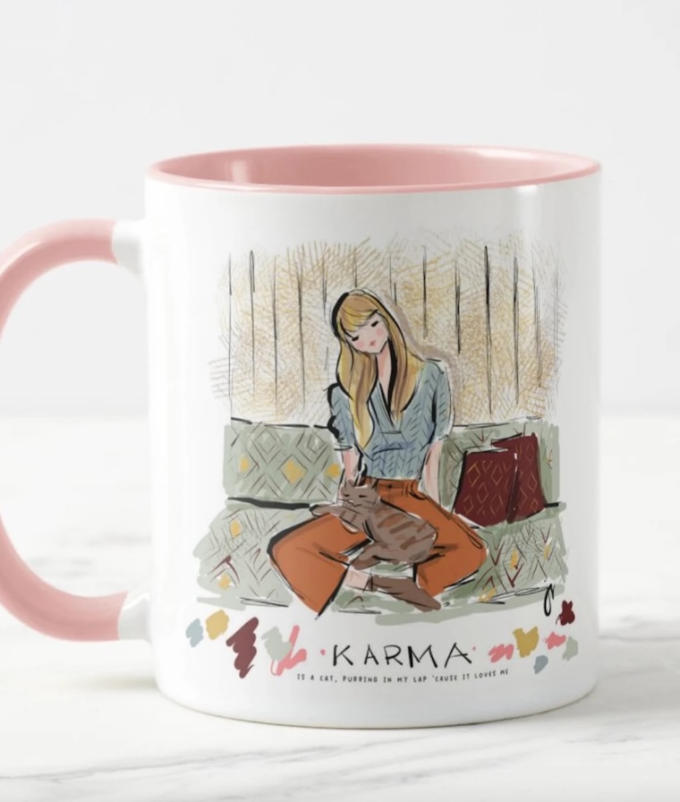 Taylor Swift gifts for fans: The Taylor Swift Karma is a Cat mug illustrated by Jennifer Vallez Taylor Swift gifts for fans: The Taylor Swift Karma is a Cat mug illustrated by Jennifer Vallez