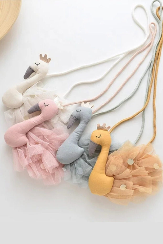 We're loving these adorable personalized purses for kids in flamingo (or cat, dog, or dino) styles by Aha Aha Moments We're loving these adorable personalized purses for kids in flamingo (or cat, dog, or dino) styles by Aha Aha Moments