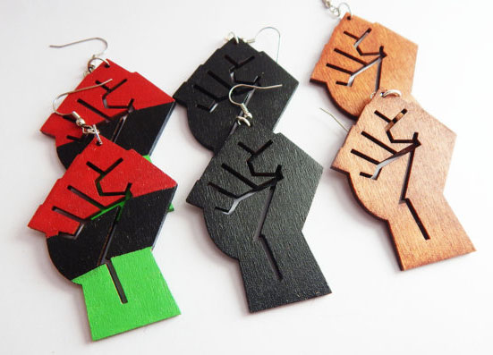 Cool feminist gifts supporting women-owned shops: Power fist earrings by The Blacker The Berry
