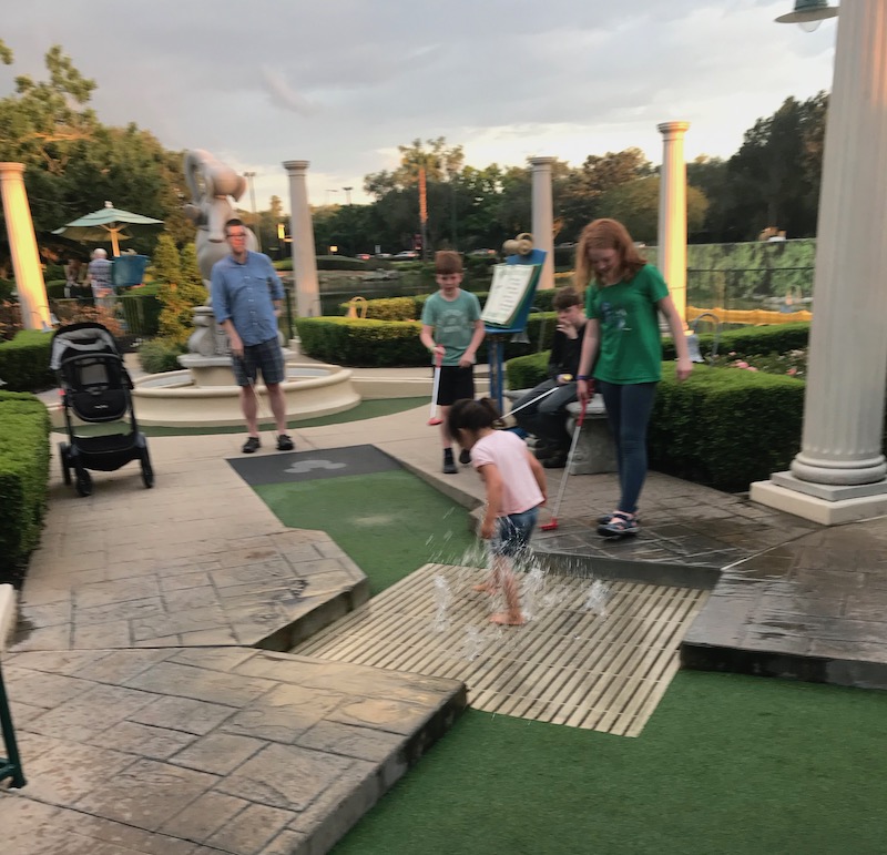 Disney World with kids with special needs: Pack extra clothes for stress-free moments of unplanned fun, like smashing in the water on the putt putt course! | (c) Kate Etue for Cool Mom Picks Disney World with kids with special needs: Pack extra clothes for stress-free moments of unplanned fun, like smashing in the water on the putt putt course! | (c) Kate Etue for Cool Mom Picks