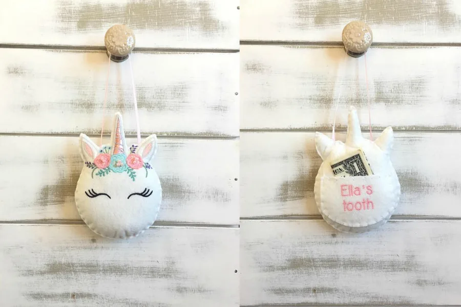 Creative tooth fairy traditions: Using a tooth fairy pillow shaped like a unicorn