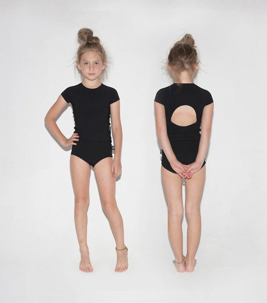 Cool black swimsuits for girls: Nununu two-piece shirtini with circle cutout