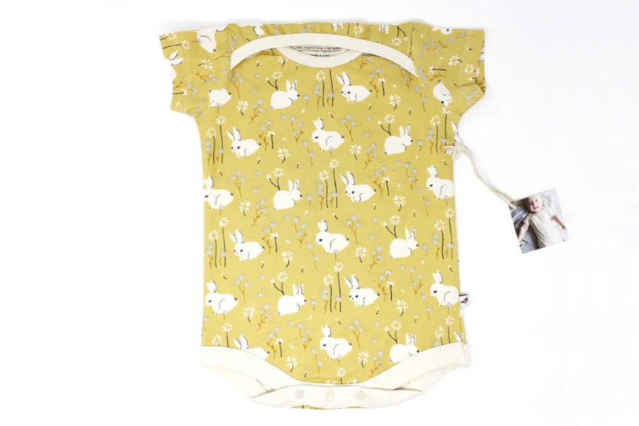 Kinderbirch's organic baby onesie featuring white bunnies is an adorable Easter gift to wear all spring and summer